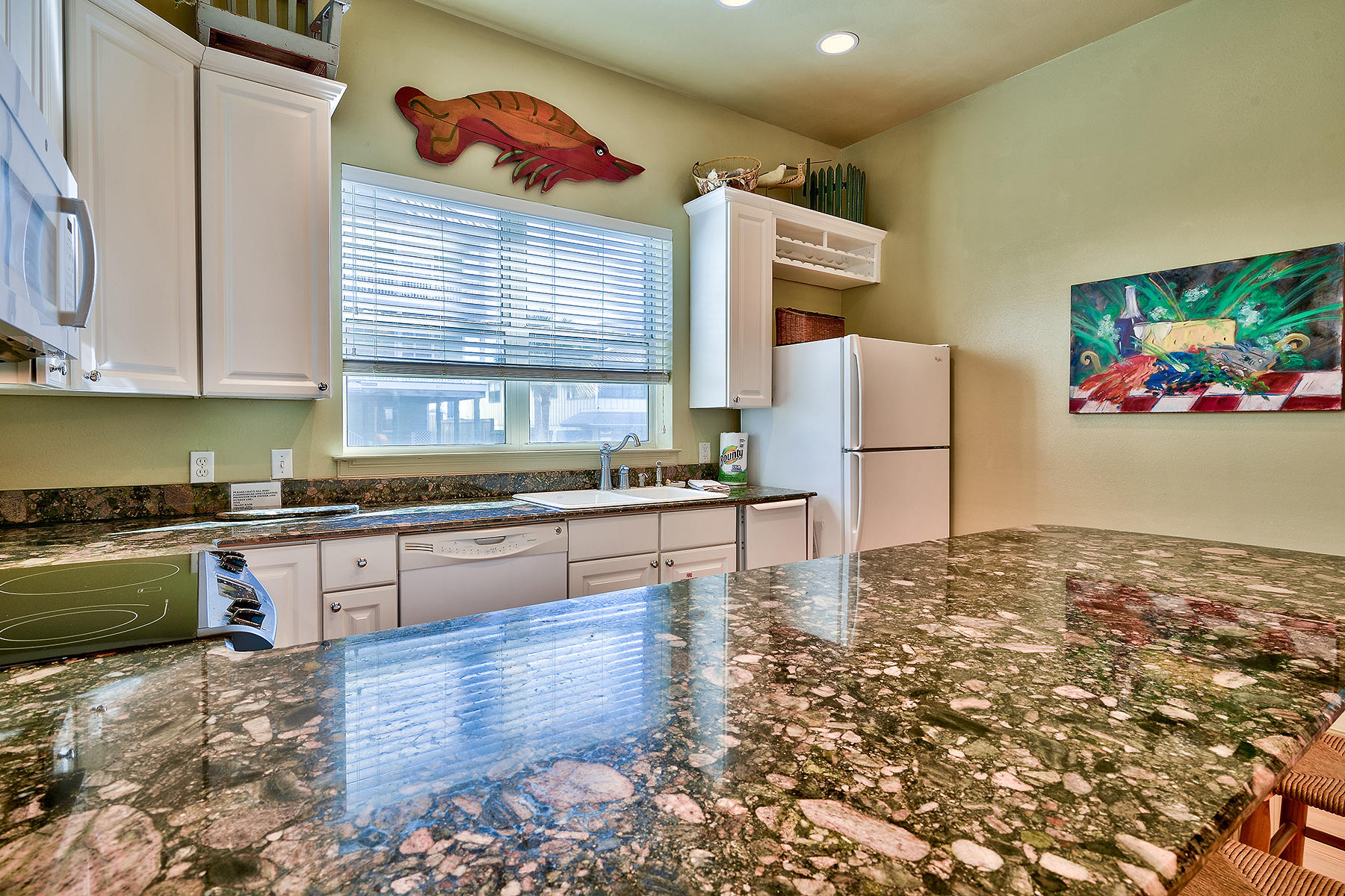 49 Cottage Street Santa Rosa Beach, FL 32459 - Photo 10 of 27 a kitchen with granite countertop a refrigerator and a stove top oven