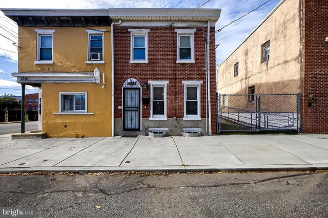a front view of a house with parking area