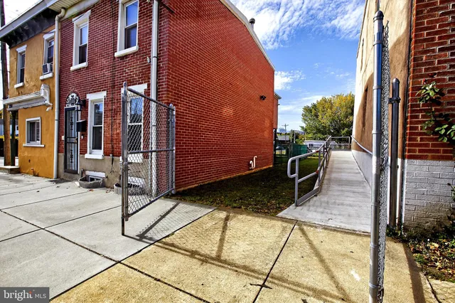 a view of a brick house with many windows