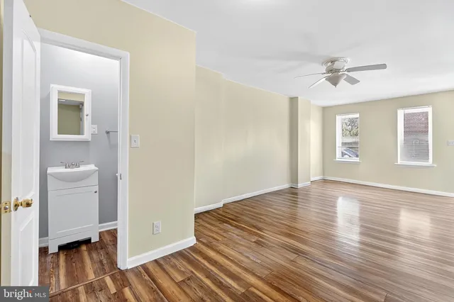 wooden floor in an empty room with a window