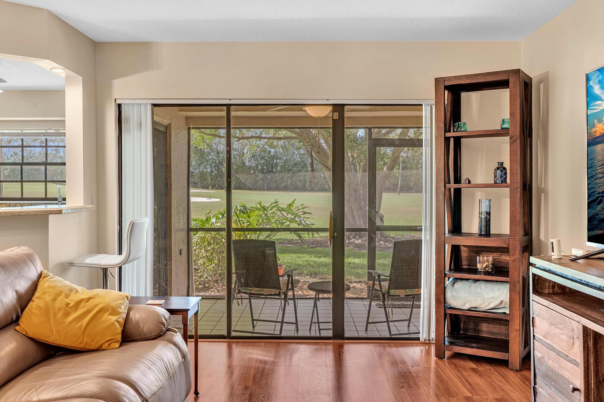 17372 Boca Club Boulevard, Unit 405 Boca Raton, FL 33487 - Photo 16 of 74 a living room with furniture and a floor to ceiling window