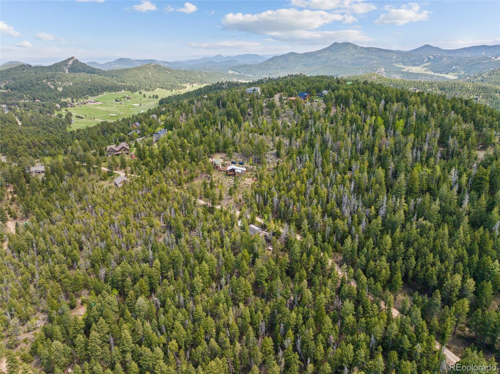 Lost Cabin Trail Evergreen, CO 80439 - Photo 15 of 17 a view of a lush green hillside and houses