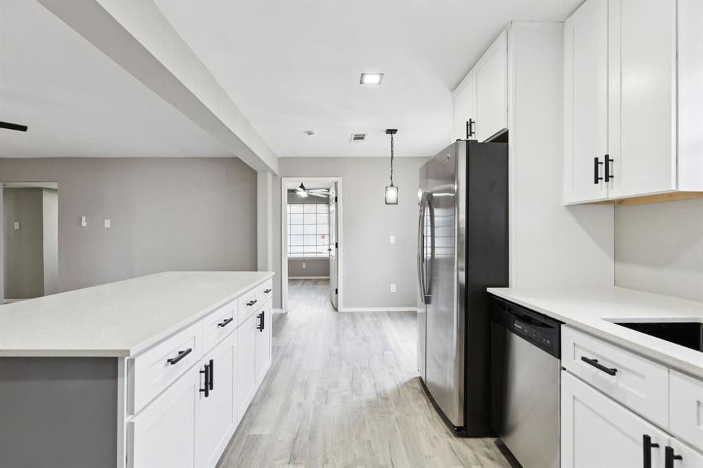 9643 Altacrest Drive Dallas, TX 75227 - Photo 11 of 30 a kitchen with stainless steel appliances a refrigerator and a stove