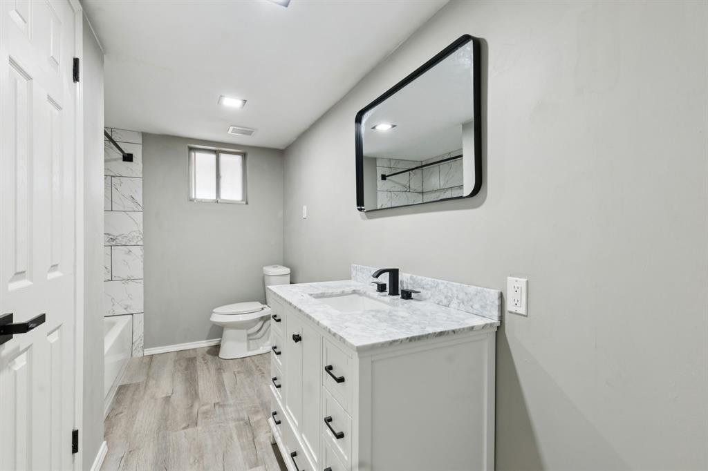 9643 Altacrest Drive Dallas, TX 75227 - Photo 15 of 30 a bathroom with a sink and a mirror