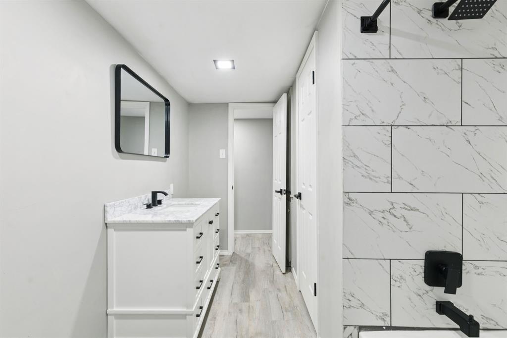 9643 Altacrest Drive Dallas, TX 75227 - Photo 17 of 30 a bathroom with a sink and a mirror