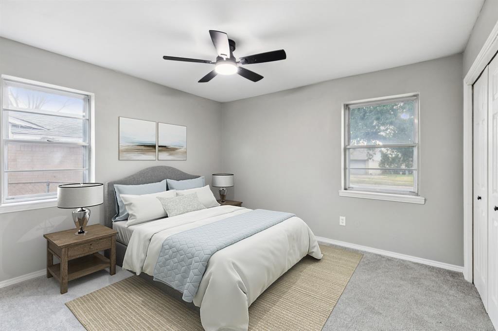 9643 Altacrest Drive Dallas, TX 75227 - Photo 20 of 30 a bedroom with a large bed and a window