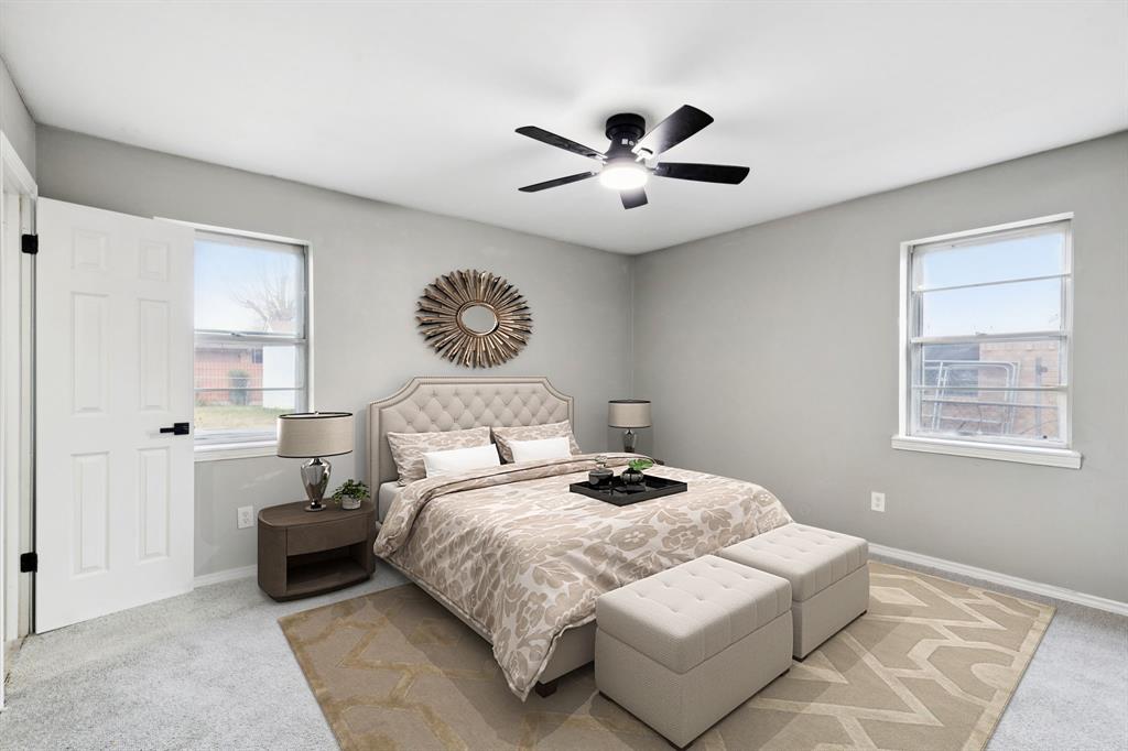 9643 Altacrest Drive Dallas, TX 75227 - Photo 23 of 30 a bedroom with a large bed and a chandelier