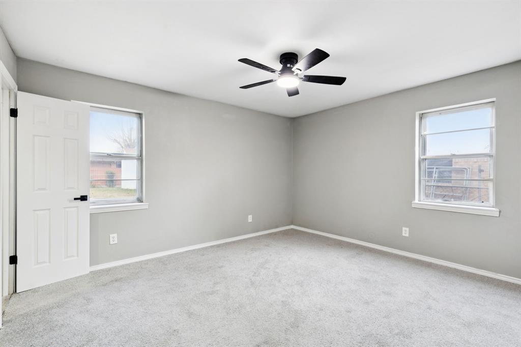 9643 Altacrest Drive Dallas, TX 75227 - Photo 24 of 30 an empty room with windows and fan