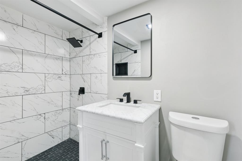 9643 Altacrest Drive Dallas, TX 75227 - Photo 26 of 30 a bathroom with a sink toilet and shower