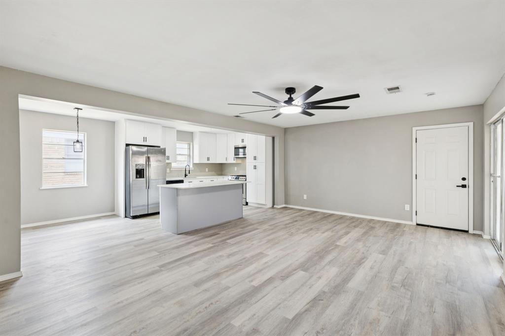 9643 Altacrest Drive Dallas, TX 75227 - Photo 4 of 30 a view of kitchen with wooden floor and window