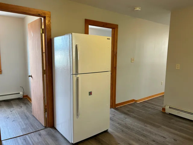 a view of walk in closet with wooden floor