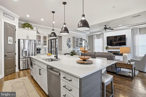 a kitchen with stainless steel appliances granite countertop a sink a stove and a refrigerator