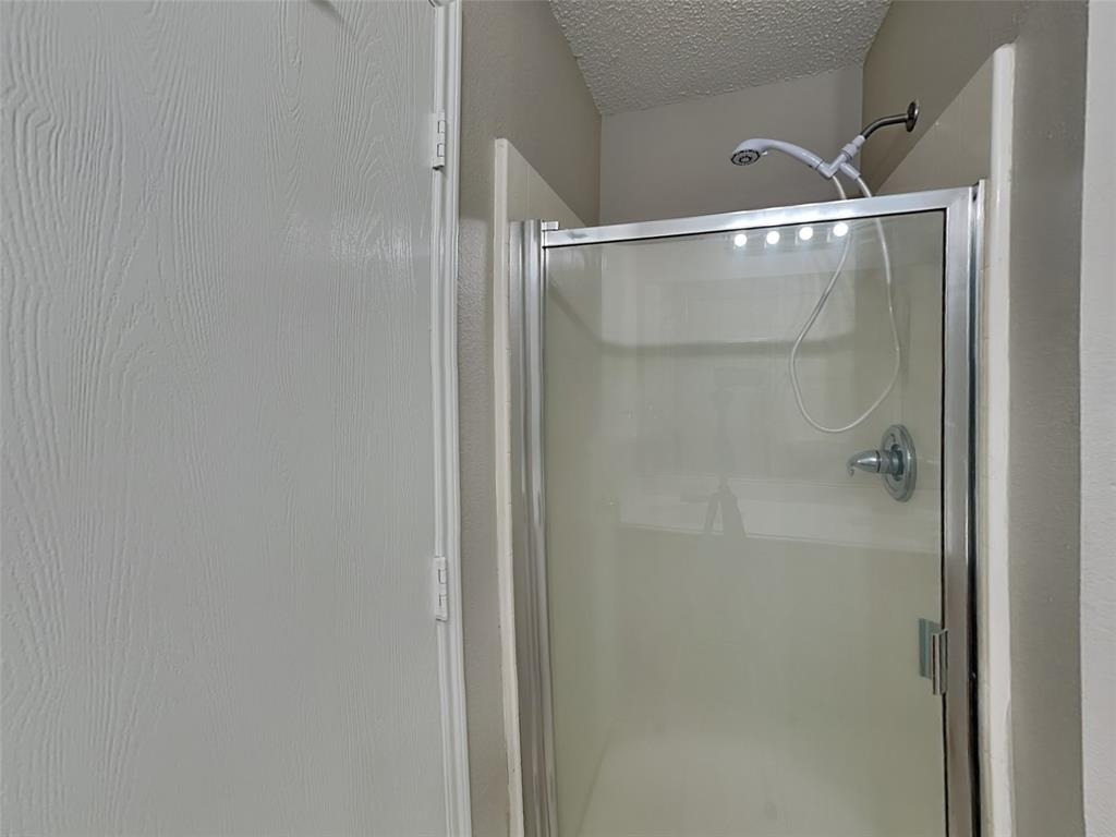 7413 Ranger Way Fort Worth, TX 76133 - Photo 11 of 19 a bathroom with a glass shower door