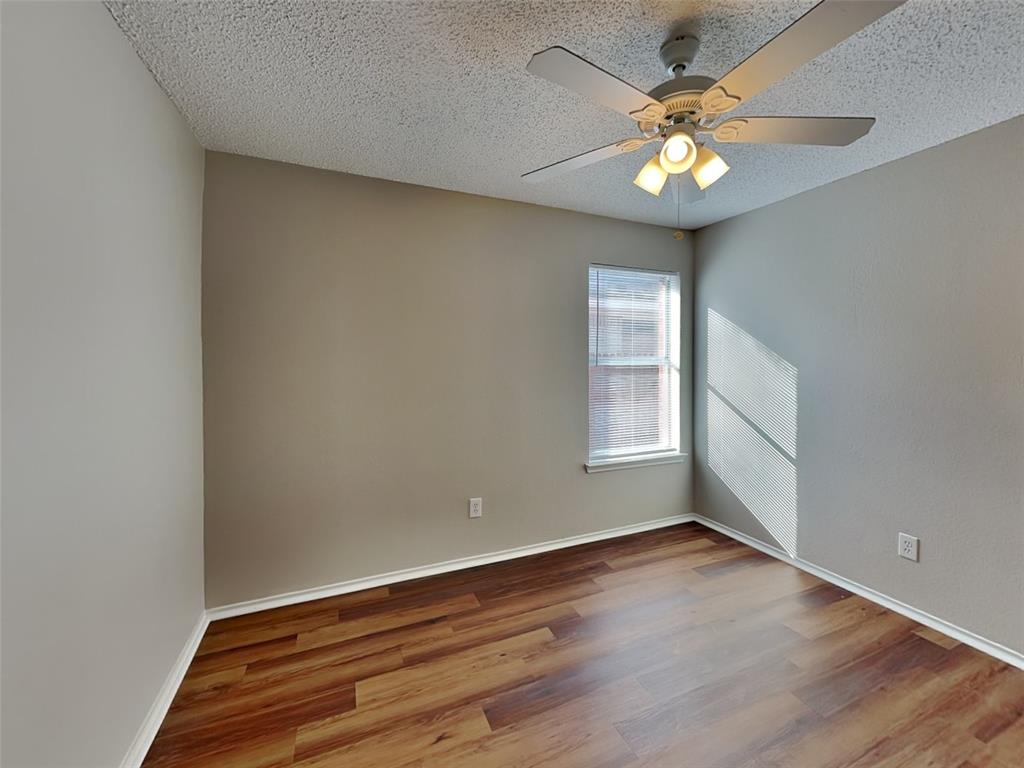 7413 Ranger Way Fort Worth, TX 76133 - Photo 12 of 19 an empty room with wooden floor and windows