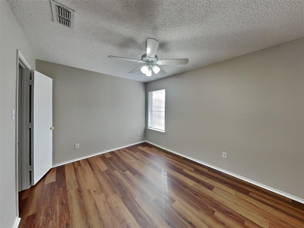 7413 Ranger Way Fort Worth, TX 76133 - Photo 14 of 19 wooden floor in an empty room with a window