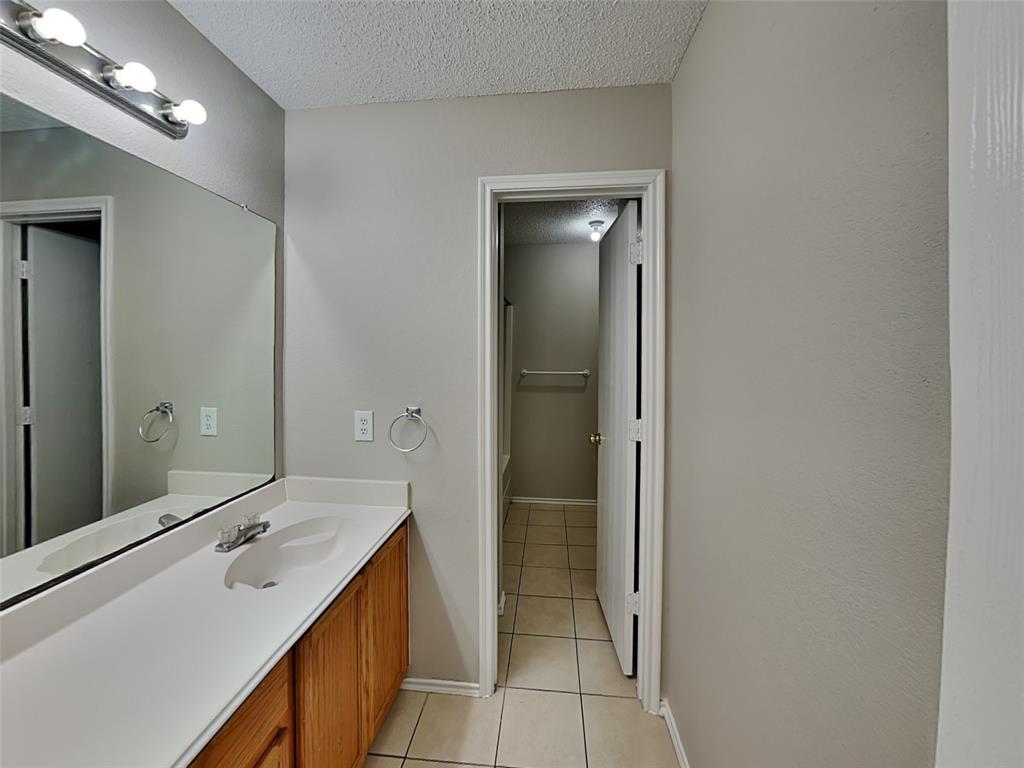 7413 Ranger Way Fort Worth, TX 76133 - Photo 17 of 19 a bathroom with a double vanity sink and mirror