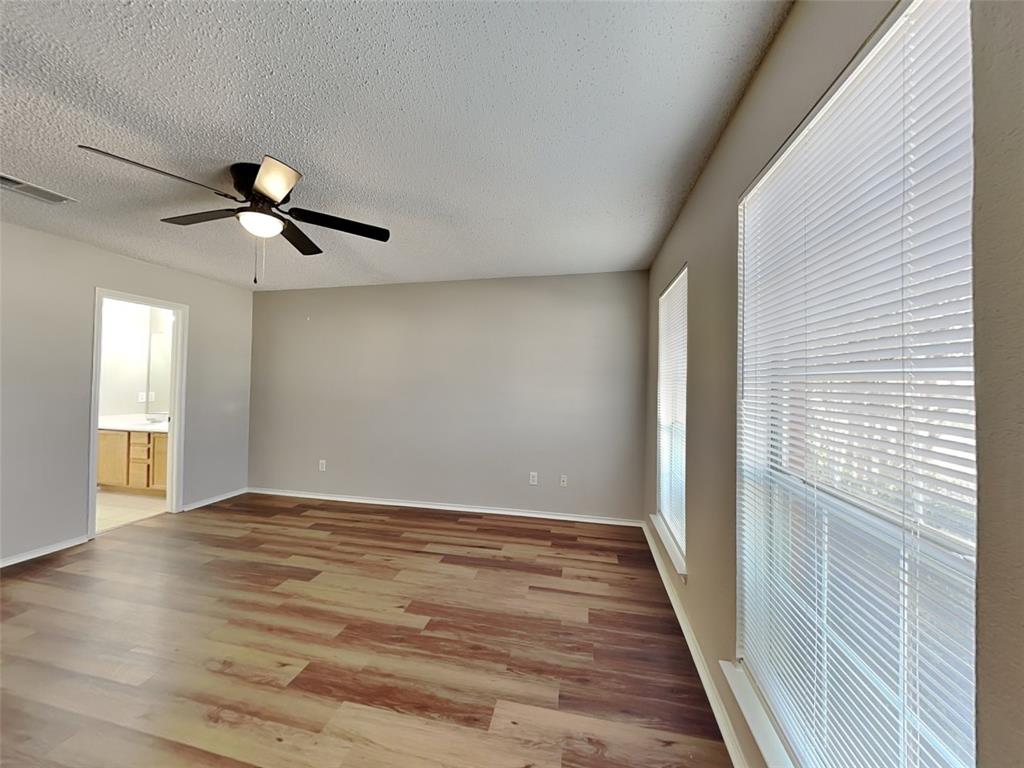 7413 Ranger Way Fort Worth, TX 76133 - Photo 7 of 19 a view of empty room with wooden floor and fan