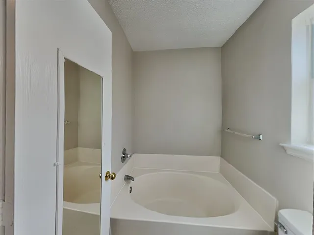 a white bath tub sitting next to a white sink