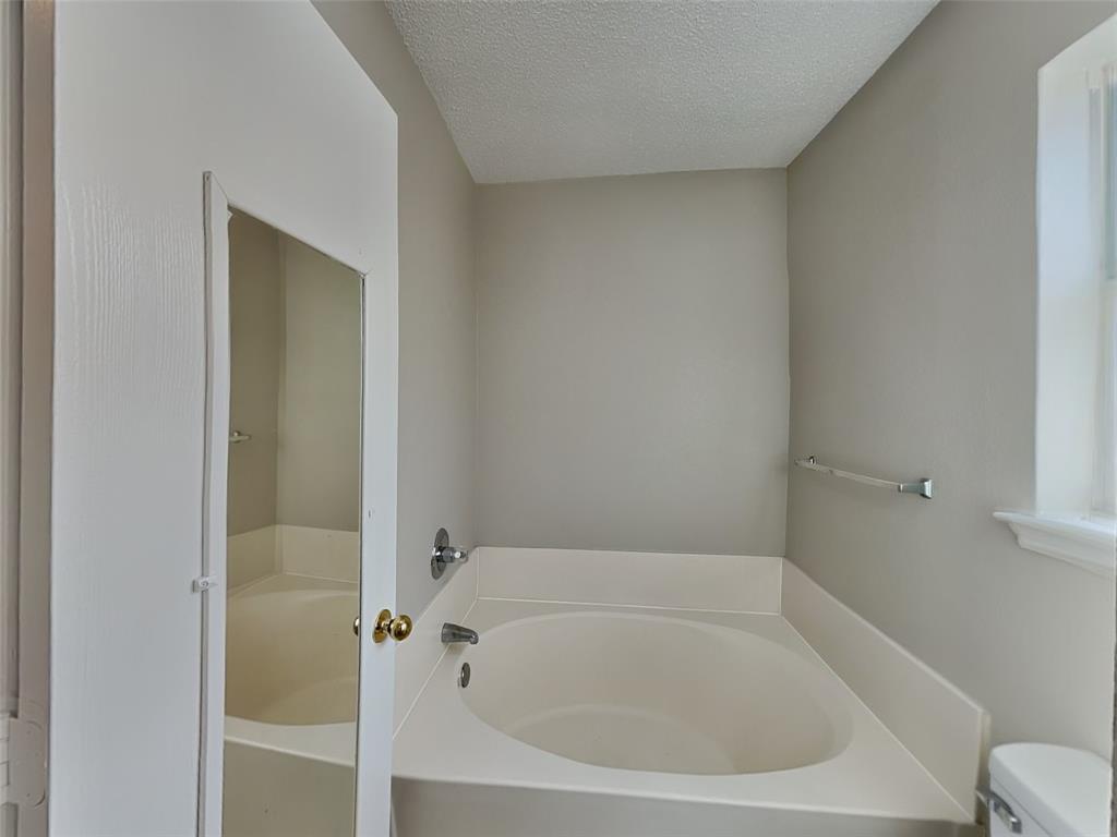 7413 Ranger Way Fort Worth, TX 76133 - Photo 10 of 19 a white bath tub sitting next to a white sink