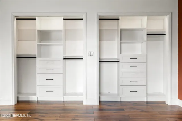 a bathroom with a granite countertop shower sink vanity and mirror