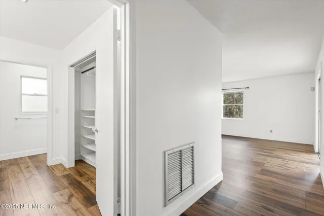 a spacious bathroom with a double vanity sink and a mirror