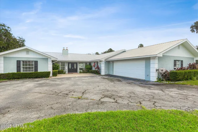 a green field with trees in the background