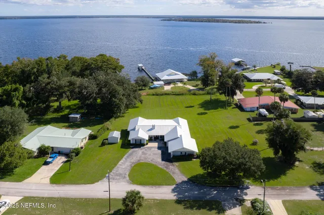 an aerial view of a house with yard swimming pool and outdoor seating