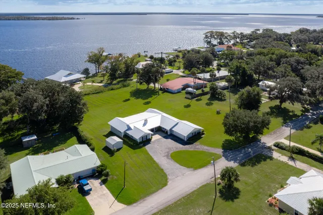 an aerial view of a house with yard swimming pool and outdoor seating