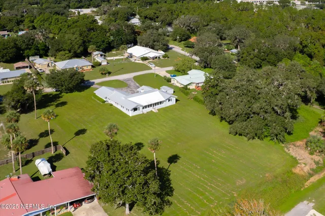 an aerial view of a house with a swimming pool yard and outdoor seating