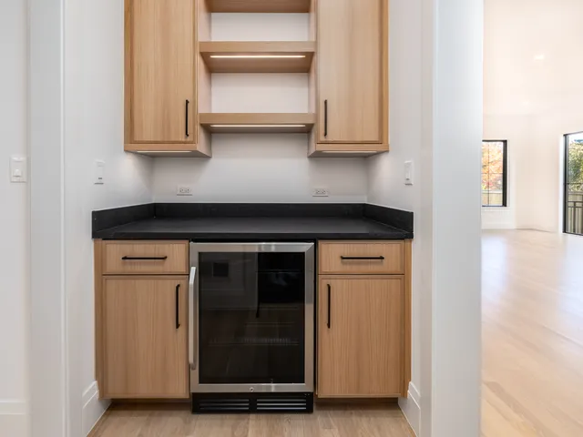 a kitchen with white cabinets and appliances