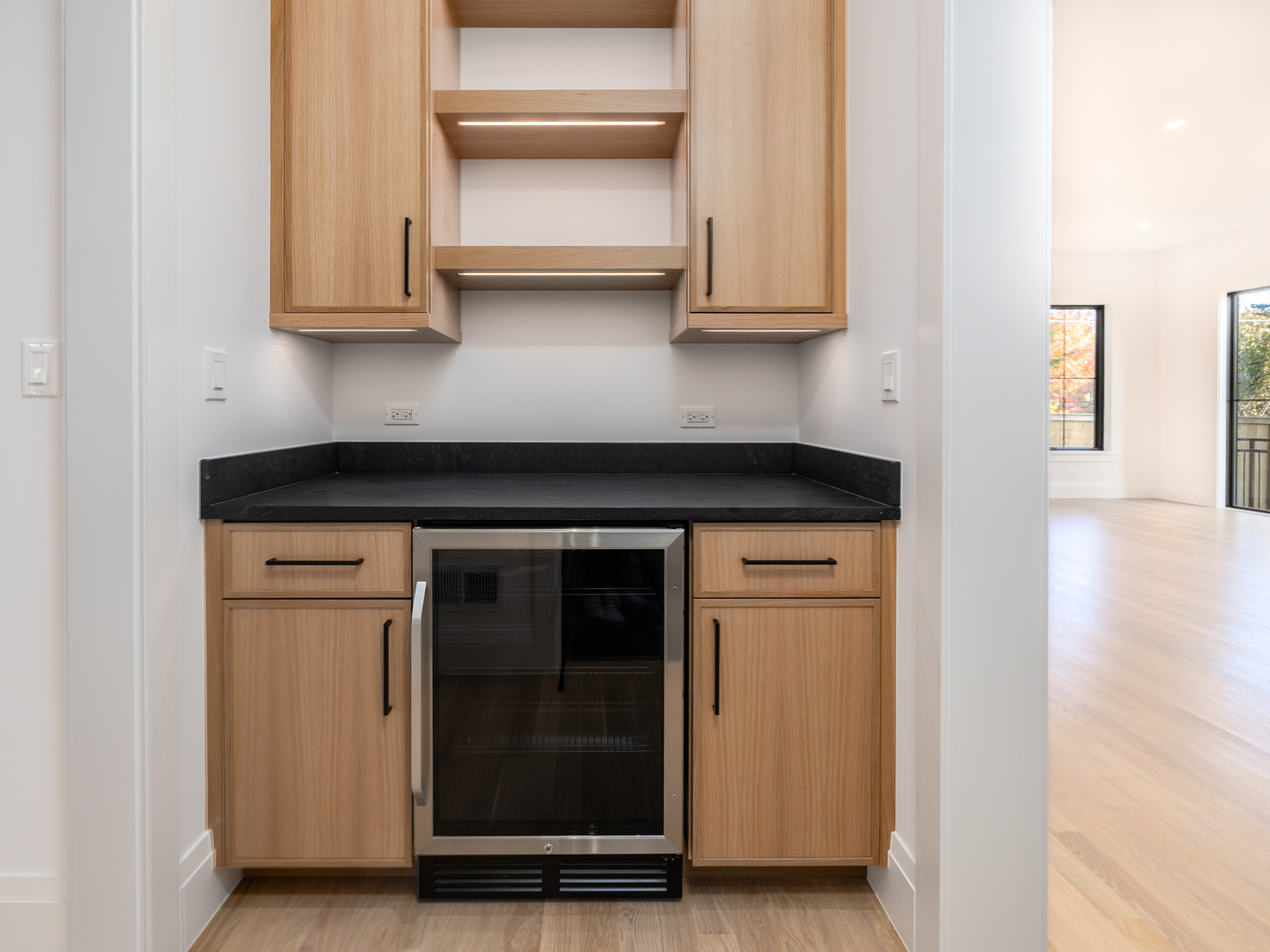 410 Prairie Avenue Wilmette, IL 60091 - Photo 6 of 44 a kitchen with granite countertop white cabinets and black appliances