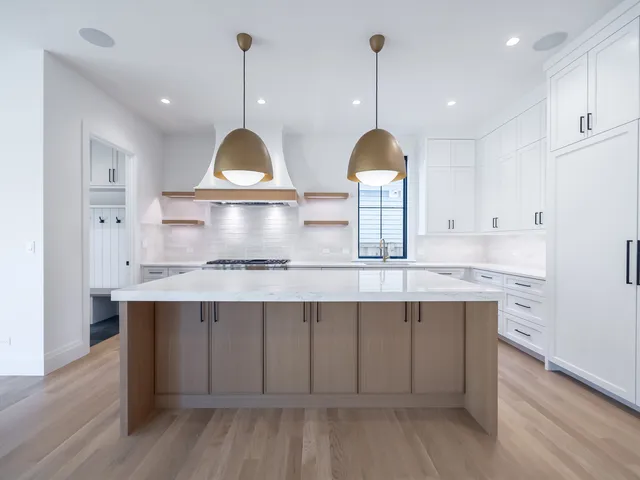 a view of a hallway with wooden floor and entryway