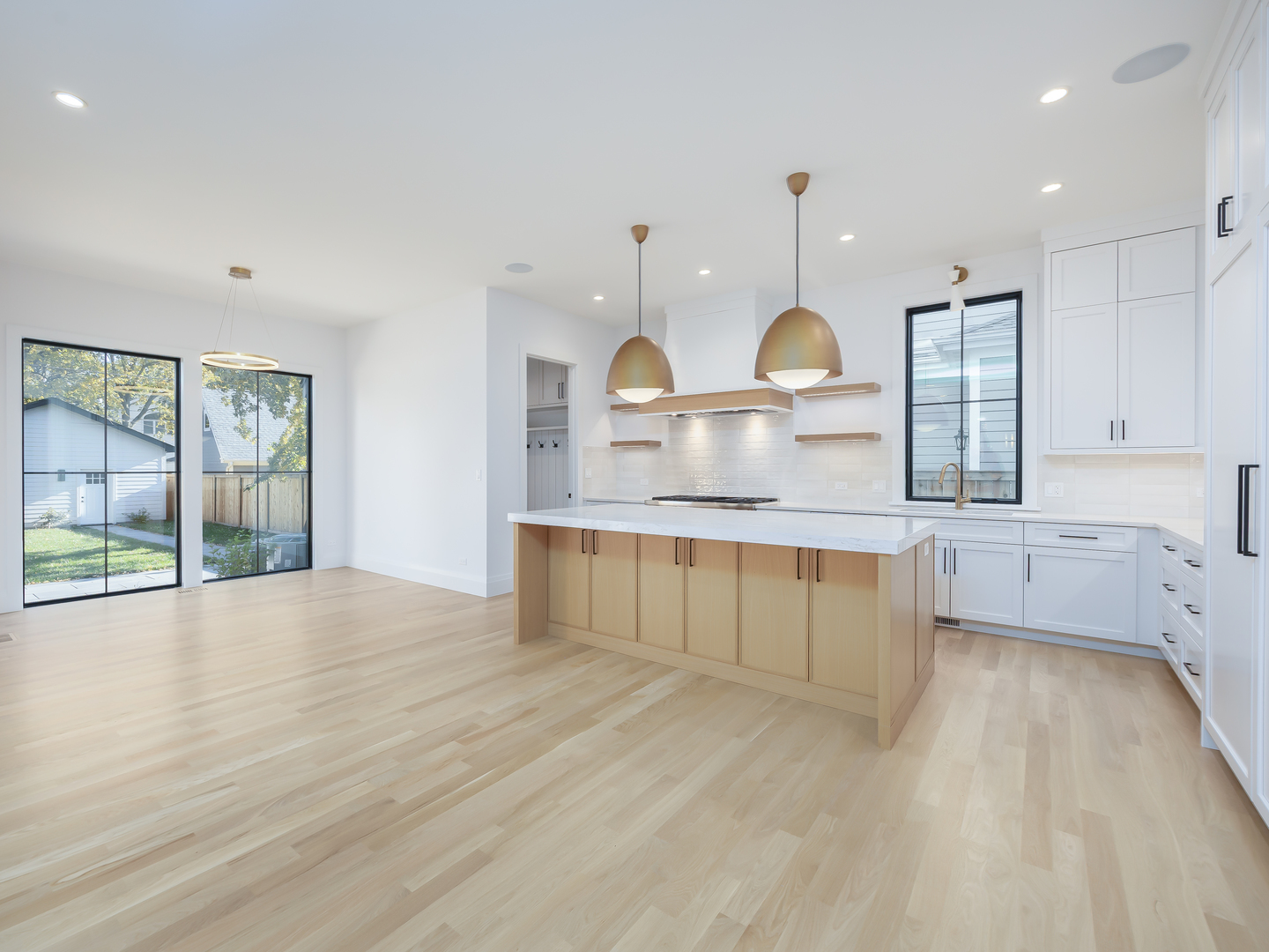 410 Prairie Avenue Wilmette, IL 60091 - Photo 10 of 44 a large kitchen with granite countertop a stove a sink a refrigerator and white cabinets with wooden floor