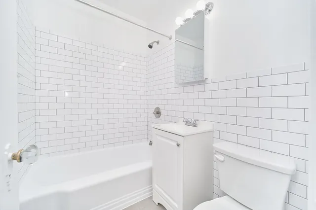 a bathroom with a sink a toilet and bathtub