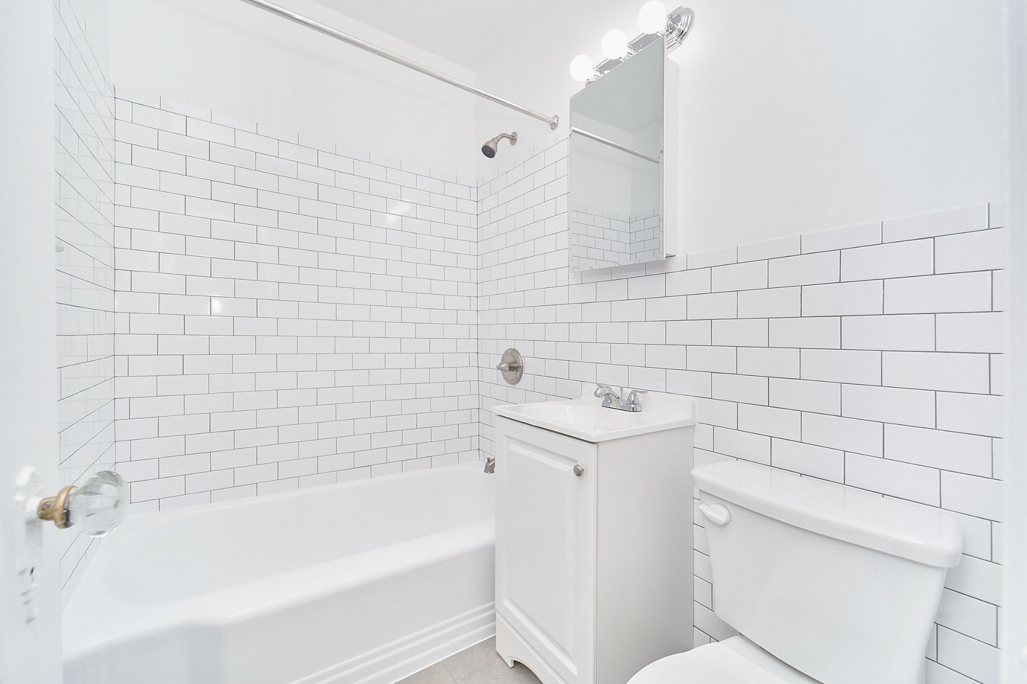 338 East 53rd Street, Unit C Manhattan, NY 10022 - Photo 3 of 10 a bathroom with a sink a toilet and bathtub