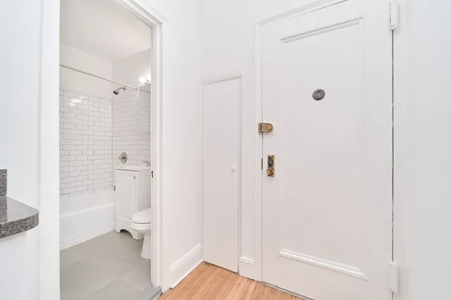a bathroom with a granite countertop toilet