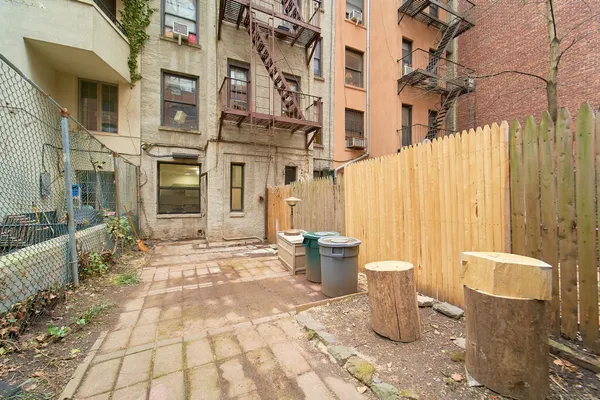a view of a patio with iron fence