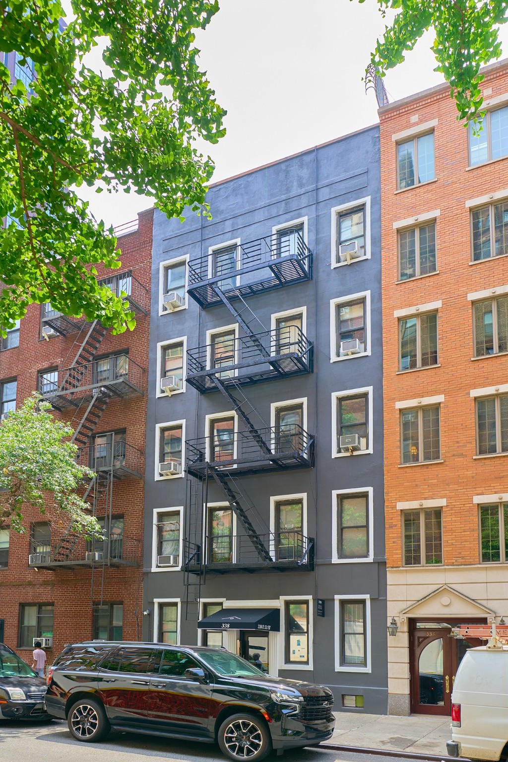 338 East 53rd Street, Unit C Manhattan, NY 10022 - Photo 8 of 10 a front view of a building with lot of cars parked