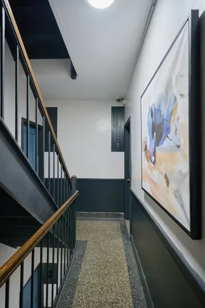 a view of staircase with wooden floor and window