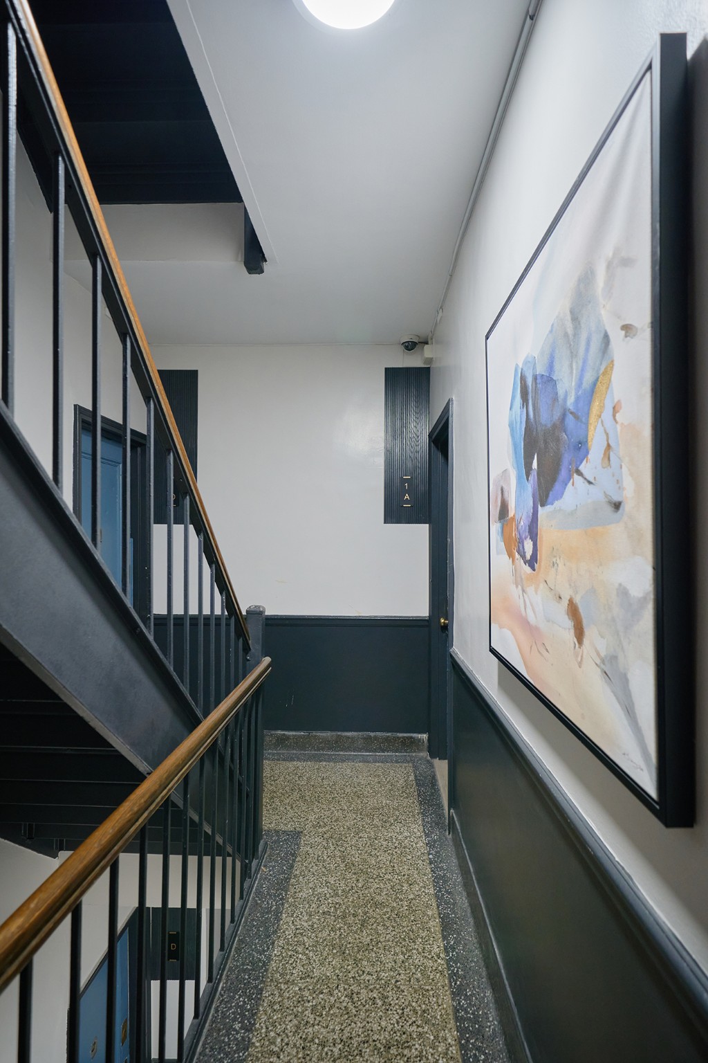 338 East 53rd Street, Unit C Manhattan, NY 10022 - Photo 9 of 10 a view of staircase with wooden floor and window