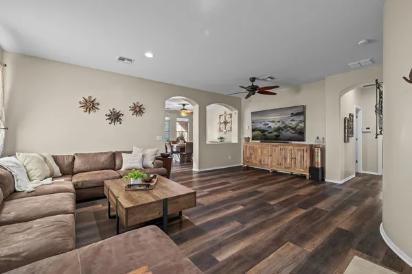 a living room with furniture and a wooden floor