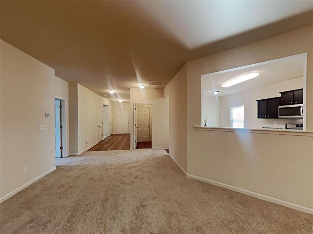 557 Scotland Drive Dallas, GA 30132 - Photo 11 of 28 a view of a hallway with wooden floor