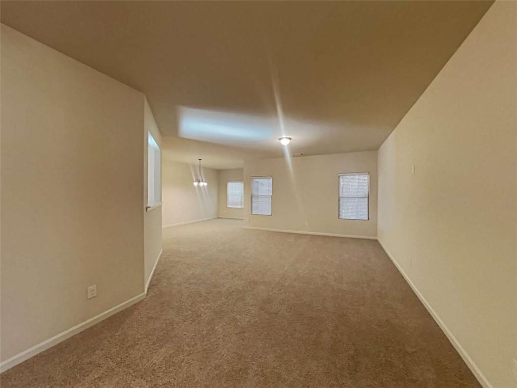 557 Scotland Drive Dallas, GA 30132 - Photo 12 of 28 a view of a big room with windows and chandelier
