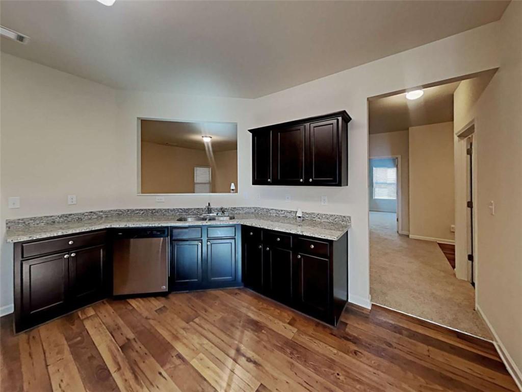 557 Scotland Drive Dallas, GA 30132 - Photo 2 of 28 a kitchen with granite countertop stainless steel appliances and wooden cabinets