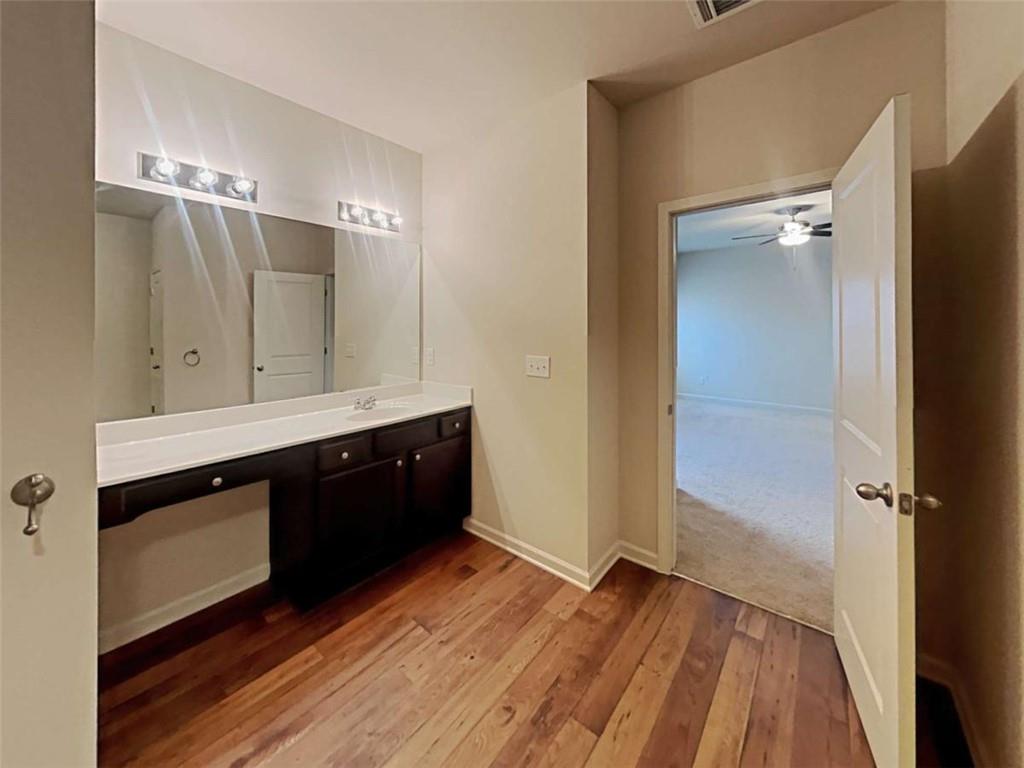 557 Scotland Drive Dallas, GA 30132 - Photo 22 of 28 a spacious bathroom with a double vanity sink and a mirror