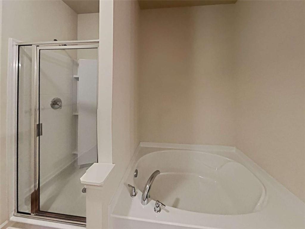 557 Scotland Drive Dallas, GA 30132 - Photo 26 of 28 a bathroom with a tub and shower