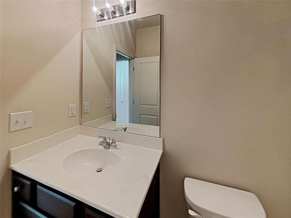 557 Scotland Drive Dallas, GA 30132 - Photo 27 of 28 a bathroom with a sink a toilet and mirror