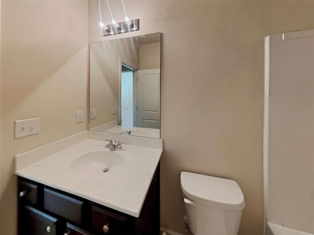 557 Scotland Drive Dallas, GA 30132 - Photo 28 of 28 a bathroom with a sink a toilet and mirror