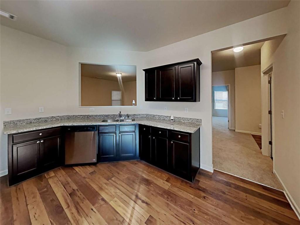 557 Scotland Drive Dallas, GA 30132 - Photo 3 of 28 a kitchen with granite countertop stainless steel appliances and a counter space