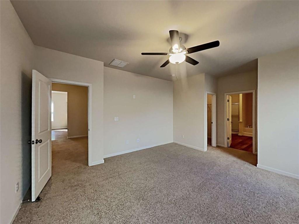 557 Scotland Drive Dallas, GA 30132 - Photo 4 of 28 a view of empty room with ceiling fan